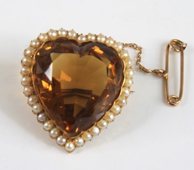 Lot 2218 - A yellow metal heart shaped citrine brooch,...