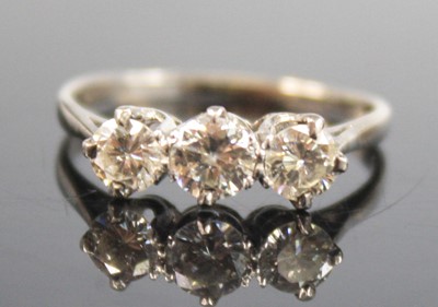 Lot 2266 - A white metal diamond three-stone ring,...