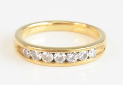 Lot 2230 - An 18ct yellow gold diamond half eternity ring,...