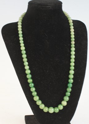 Lot 2257 - A single row of 71 graduated jadeite beads,...