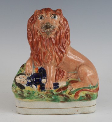 Lot 2073 - A Staffordshire model of the British lion over...