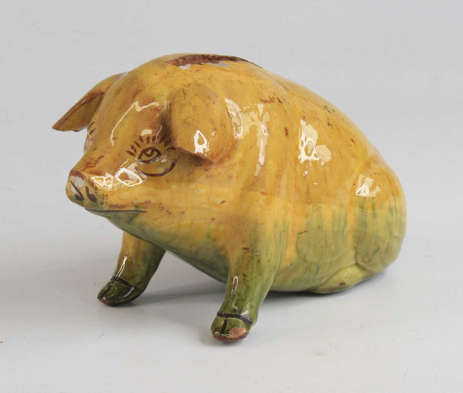 Lot 2091 - An Ewenny pottery piggy bank, shown in seated...