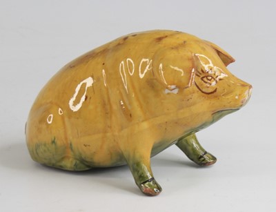 Lot 2091 - An Ewenny pottery piggy bank, shown in seated...