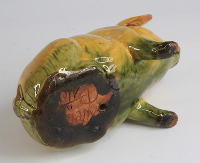 Lot 240 - An Ewenny pottery piggy bank, shown in seated...