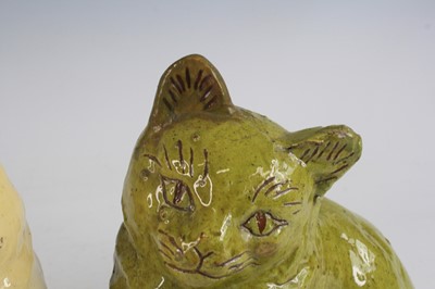Lot 2092 - A near pair of Ewenny pottery models of cats,...