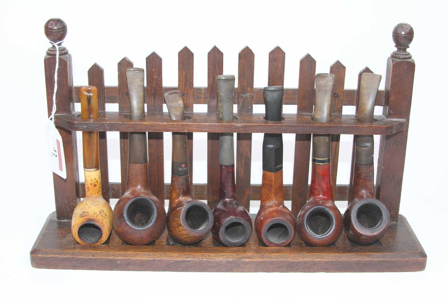 Lot 42 - An early 20th century oak pipe rack in the...