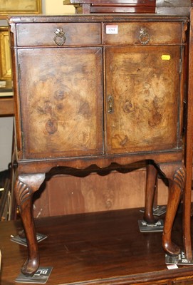 Lot 1186 - A small 1930s figured walnut double door...