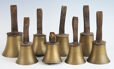 Lot 256 - Campanology, a set of eight musical hand bells,...