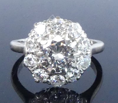 Lot 2280 - A white metal diamond circular cluster ring,...