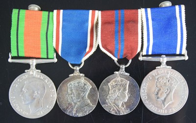 Lot 19 - A group of four medals, to include WW II...