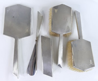 Lot 1144 - An Art Deco five-piece silver backed dressing...