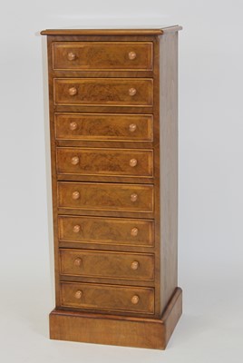 Lot 2536 - A walnut and figured walnut eight drawer chest,...