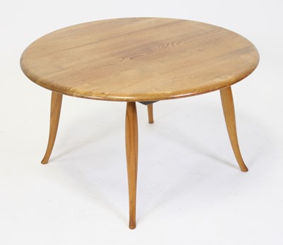 Lot 1386 - A 1960s Ercol elm circular low coffee table,...