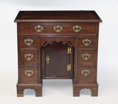 Lot 2483 - A George III mahogany kneehole desk, having an...