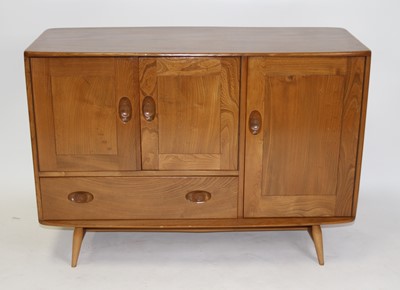 Lot 1394 - An Ercol light elm Windsor compact sideboard,...