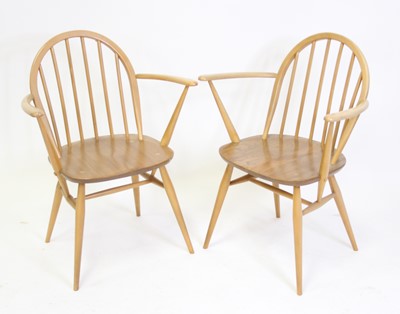 Lot 1391 - A pair of Ercol light elm stickback elbow...