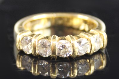 Lot 2237 - An 18ct yellow gold diamond half eternity ring,...