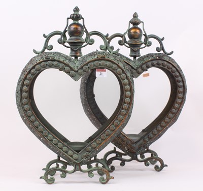 Lot 21 - A pair of modern verdigris metal heart shaped...