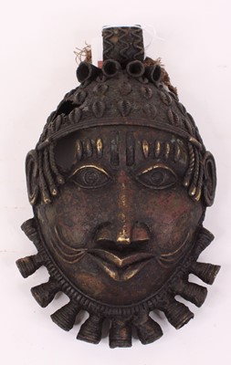 Lot 33 - An African gilt metal mask, possibly Benin,...