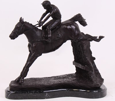 Lot 51 - A bronze model of a horse and jockey, upon a...