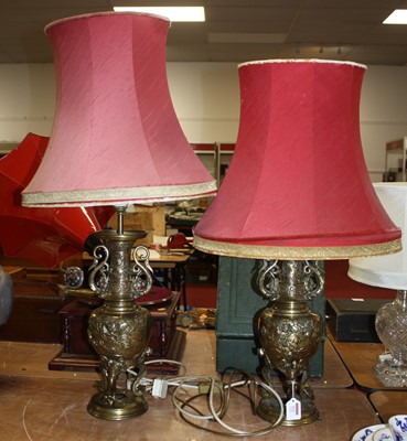 Lot 112 - A pair of Chinese brass table lamps, relief...