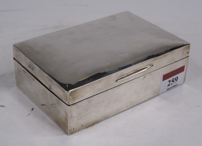 Lot 259 - An Edwardian silver-clad table cigarette box,...