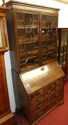 Lot 1112 - A George III mahogany bureau bookcase, having...