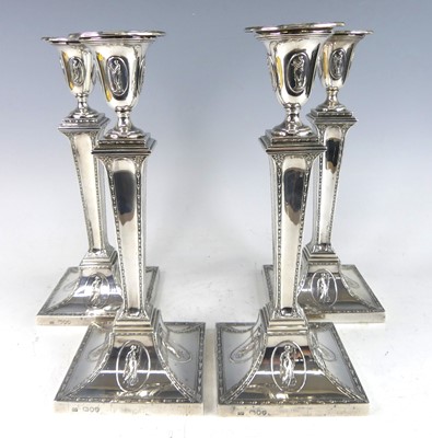 Lot 2144 - A set of four Victorian silver candlesticks in...