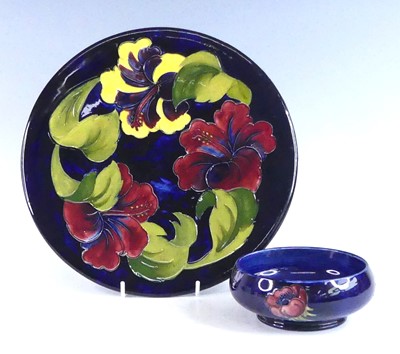 Lot 1028 - A Moorcroft Hibiscus pattern pottery charger,...