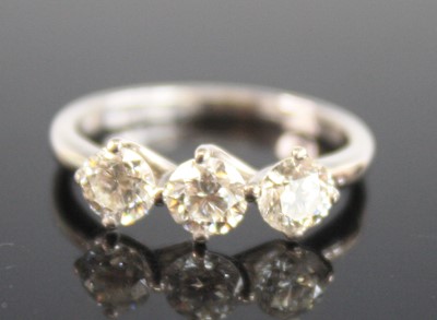 Lot 2267 - An 18ct white gold diamond trilogy ring,...