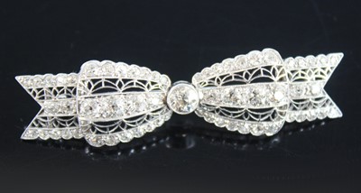 Lot 2224 - A white metal Art Deco bow brooch, featuring...