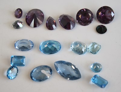Lot 2526 - A collection of loose vari-cut blue topaz and...