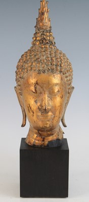 Lot 2355 - A gilt bronze head of Buddha Shakyamuni,...