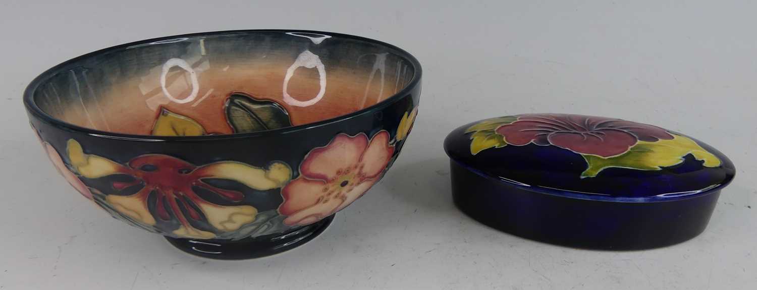 Lot 1033 - A contemporary Moorcroft footed pottery table...