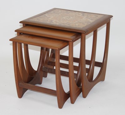 Lot 1353 - A 1960s G-plan teak and tiled inset nest of...