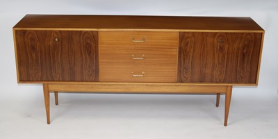 Lot 1379 - A 1960s Uniflex teak long sideboard, having...