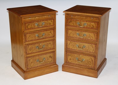 Lot 2499 - A pair of oak four drawer bedside chests, each...