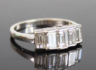 Lot 2270 - A white metal diamond half hoop ring,...