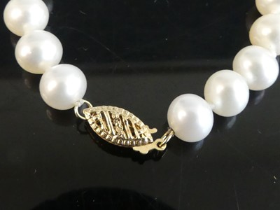 Lot 2532 - A single row of 59 cultured freshwater pearls...