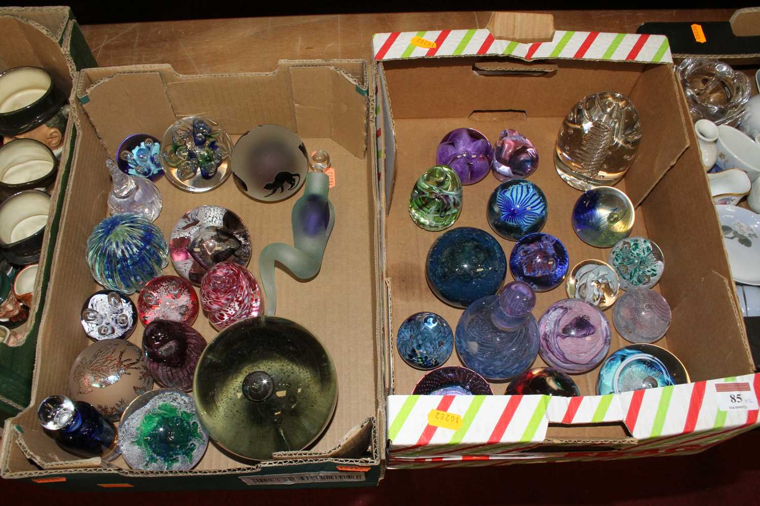 Lot 85 - Two boxes of glass paperweights, to include...