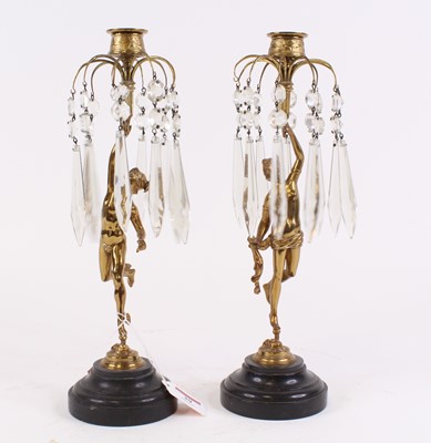 Lot 39 - A pair of figural brass table candlesticks,...