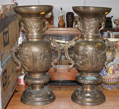 Lot 147 - A pair of Chinese brass vases, each relief...