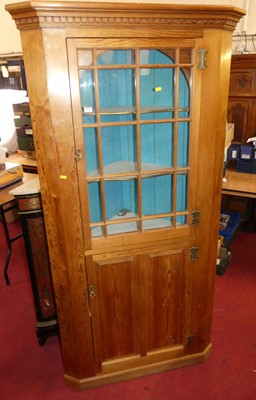 Lot 1113 - A pitch pine freestanding corner cupboard,...