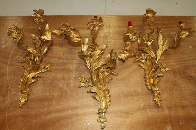 Lot 179 - A set of three Rococo style brass three-branch...