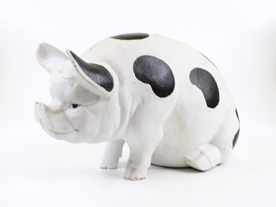 Lot 184 - A cast metal model of a pig shown seated,...