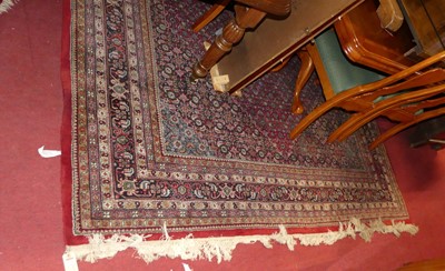 Lot 1148 - A Persian woollen red ground Tabriz rug,...