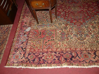 Lot 1151 - A Persian woollen red ground Heriz rug, 345 x...