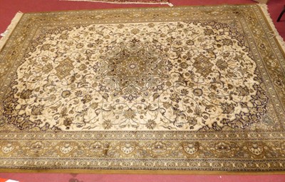 Lot 1152 - A Persian style green ground machine woven rug,...