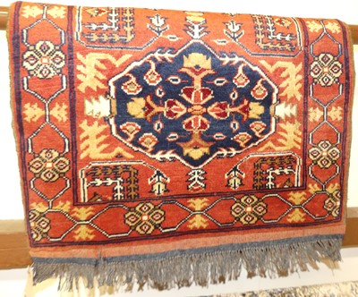 Lot 1153 - A small Persian woollen red ground Tabriz rug,...