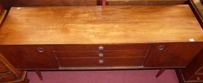 Lot 1256 - A 1960s teak sideboard, having three long...